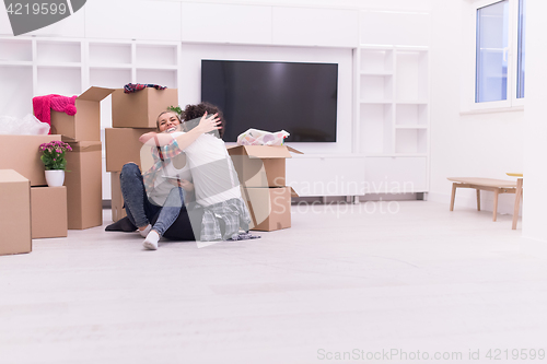 Image of young couple moving  in new house