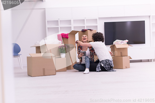 Image of young couple moving  in new house