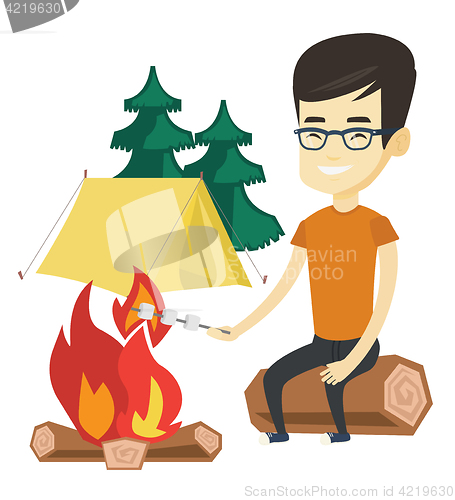 Image of Woman roasting marshmallow over campfire.