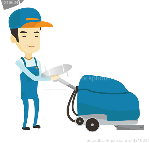 Image of Worker cleaning store floor with machine.