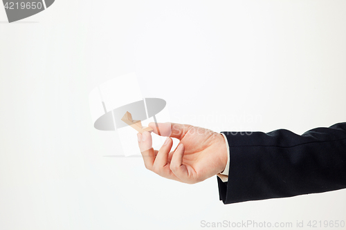 Image of Man\'s hands holding wooden puzzle.