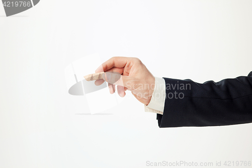 Image of Man\'s hands holding wooden puzzle.