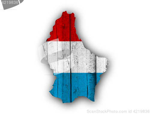 Image of Map and flag of Luxembourg on weathered wood