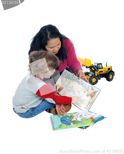 Image of Little boy reading his books.