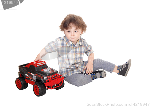 Image of Sweet three year boy playing with his truck.