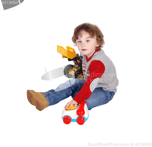 Image of Little boy playing with his toys.