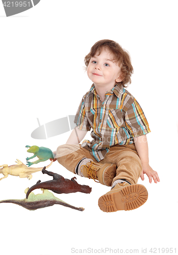 Image of Smiling little boy with his toys.