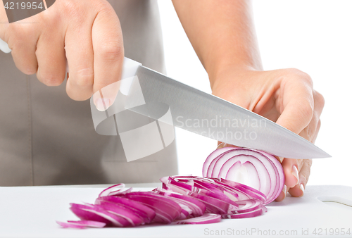 Image of Cook is chopping onion