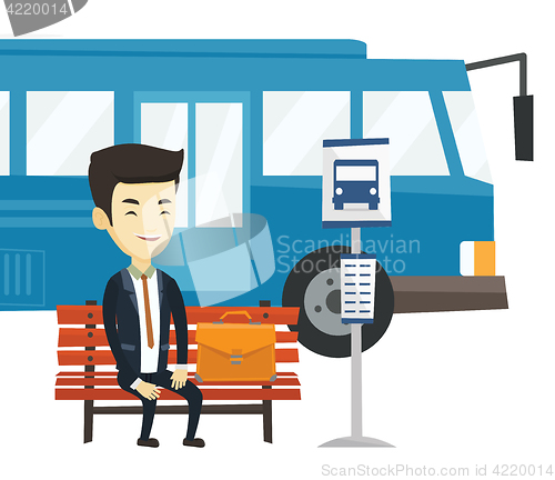 Image of Business man waiting at the bus stop.