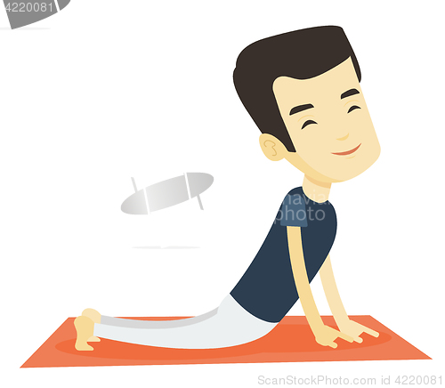 Image of Man practicing yoga upward dog pose.