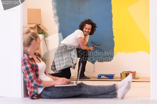 Image of Happy couple doing home renovations