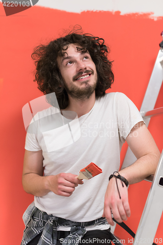 Image of man with funny hair over color background with brush