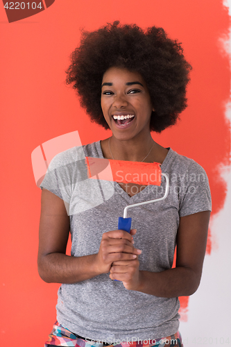 Image of black woman painting wall