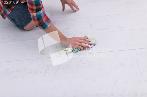 Image of woman cleaning the floor