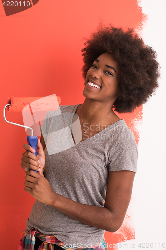 Image of black woman painting wall