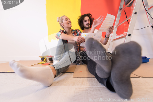 Image of Happy young couple relaxing after painting