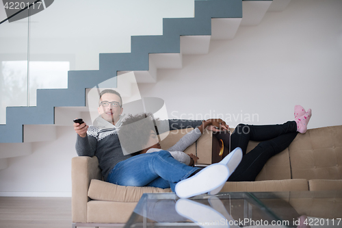 Image of multiethnic couple relaxing at home