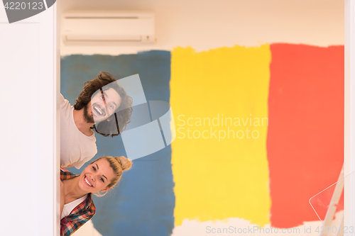 Image of portrait of a couple painting interior wall