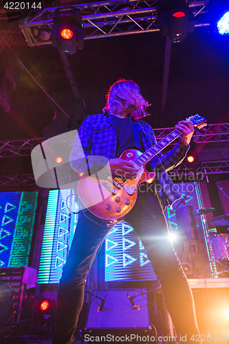 Image of The blur silhouette of rock musician at abstract rock concert