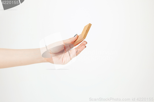 Image of The toy wooden puzzle in hand isolated on white background