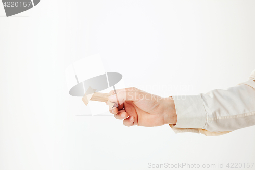 Image of The toy wooden puzzle in hand isolated on white background