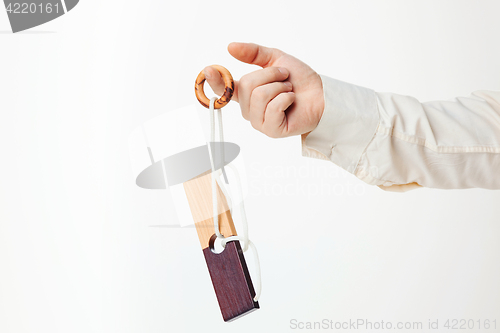 Image of The toy wooden puzzle in hand isolated on white background