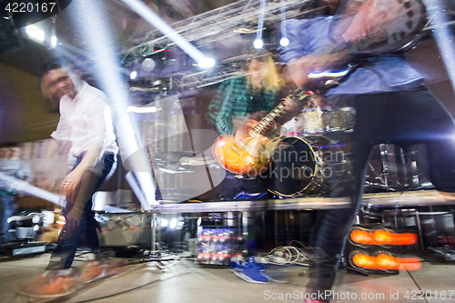 Image of The blur silhouette of rock musician at abstract rock concert