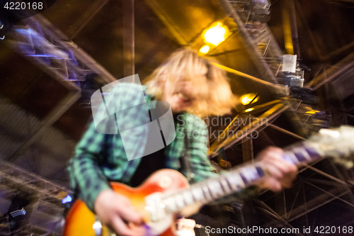 Image of The blur silhouette of rock musician at abstract rock concert