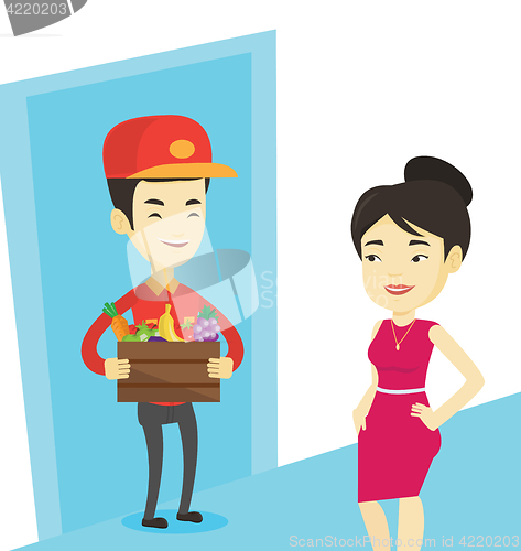 Image of Delivery courier delivering groceries to customer.
