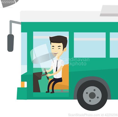 Image of Asian bus driver sitting at steering wheel.
