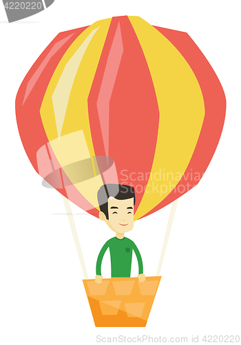 Image of Young man flying in hot air balloon.