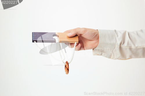 Image of The toy wooden puzzle in hand isolated on white background