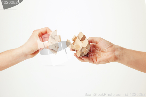 Image of puzzle in hand isolated on white background