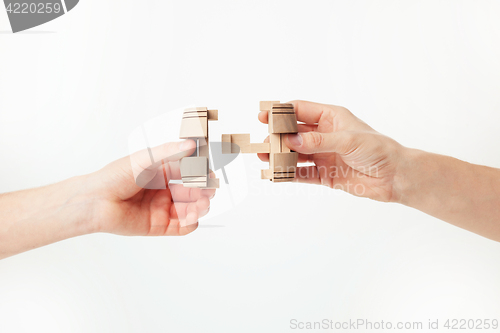 Image of puzzle in hand isolated on white background