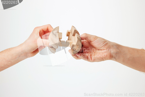 Image of puzzle in hand isolated on white background