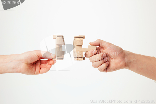 Image of puzzle in hand isolated on white background