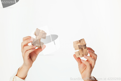 Image of puzzle in hand isolated on white background