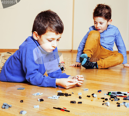 Image of funny cute children playing toys at home, boys happy smiling, first education role lifestyle 