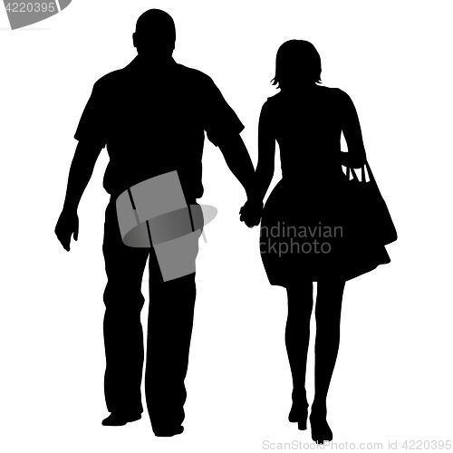 Image of Silhouette man and woman walking hand in hand