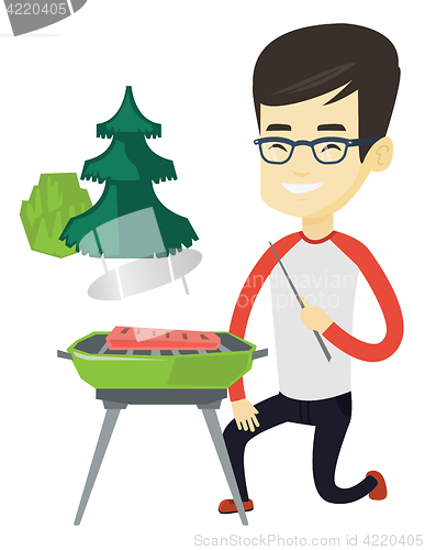 Image of Man cooking steak on barbecue grill.
