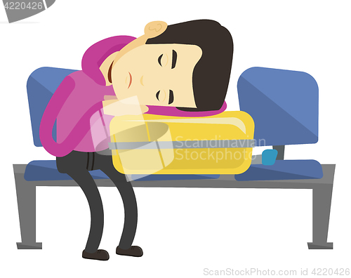 Image of Exhausted man sleeping on suitcase at airport.