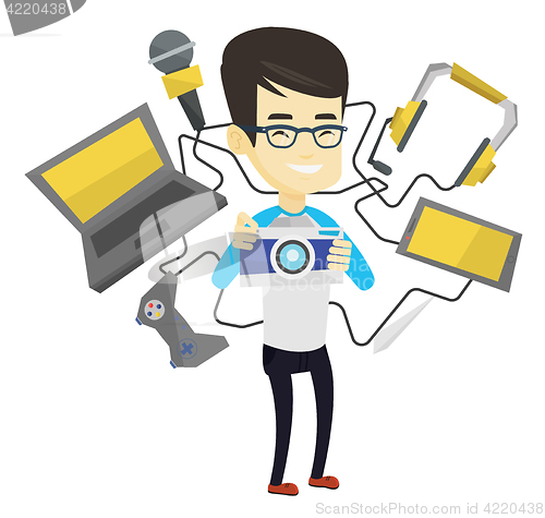 Image of Young man surrounded with his gadgets.