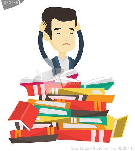 Image of Student sitting in huge pile of books.