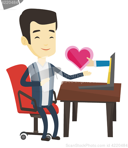 Image of Young man dating online using laptop.