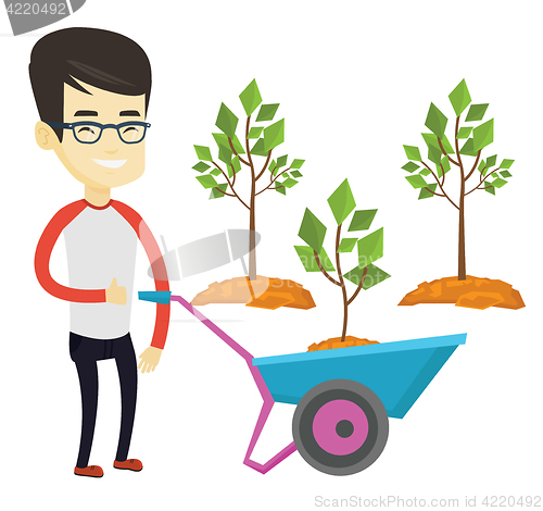 Image of Man pushing wheelbarrow with plant.