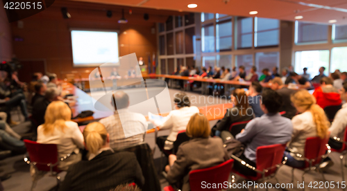 Image of Public speaker giving talk at business event.