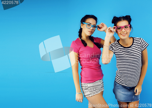 Image of best friends teenage school girls together having fun, posing emotional on blue background, besties happy smiling, lifestyle people concept 