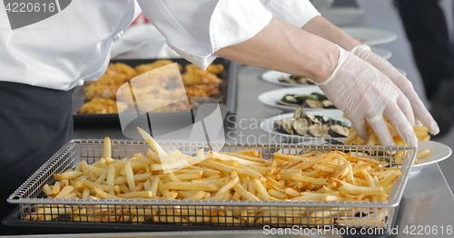 Image of French fries and meat on the table