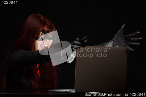 Image of Brunette at night near computer