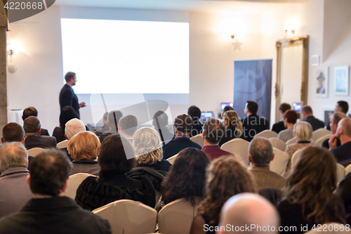 Image of Public speaker giving talk at Business Event.